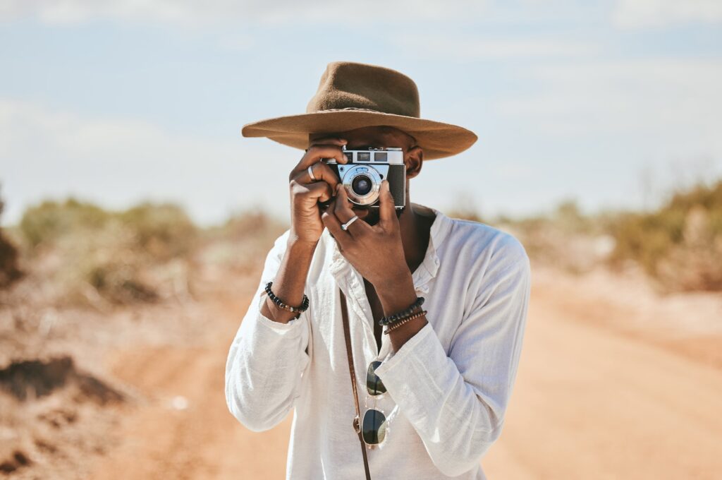 Travel, photographer and man in a desert in Australia, taking photograph of nature, beauty and eart